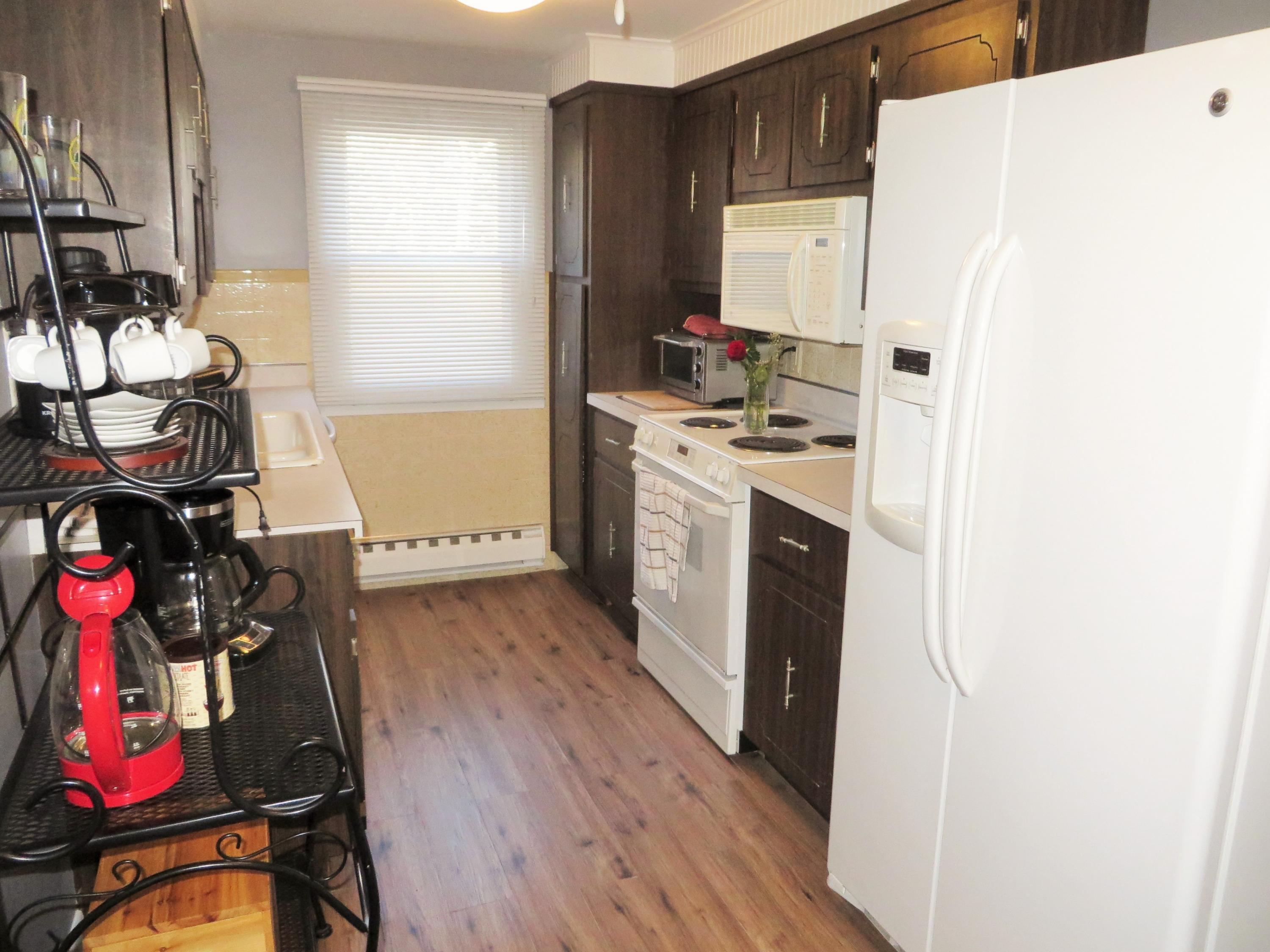 112 Old Wharf Road, Unit W9 Dennis Port, MA 02639 - Photo 8 of 19 a kitchen with furniture a refrigerator and a stove