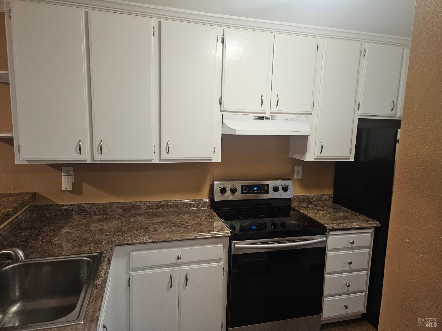 1702 Glenbrook Drive, Unit D Santa Rosa, CA 95401 - Photo 3 of 7 a kitchen with granite countertop a sink stove and cabinets