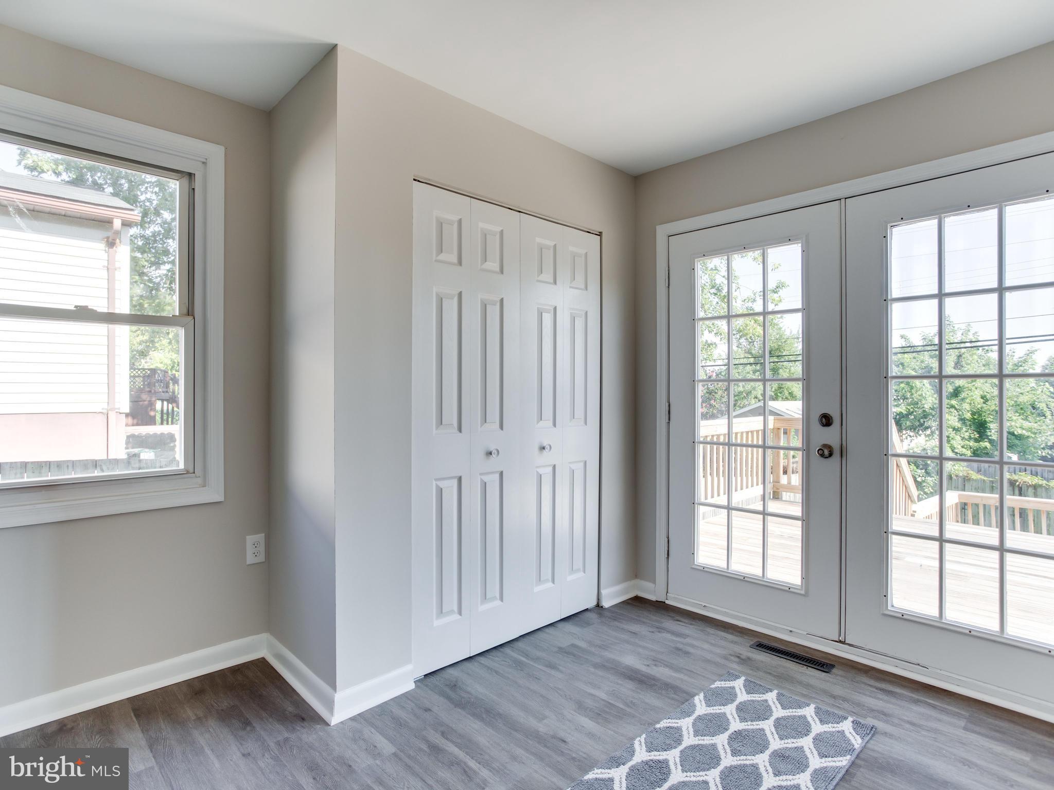 110 West Hilltop Road Baltimore, MD 21225 - Photo 16 of 30 a view of an empty room with wooden floor and a window