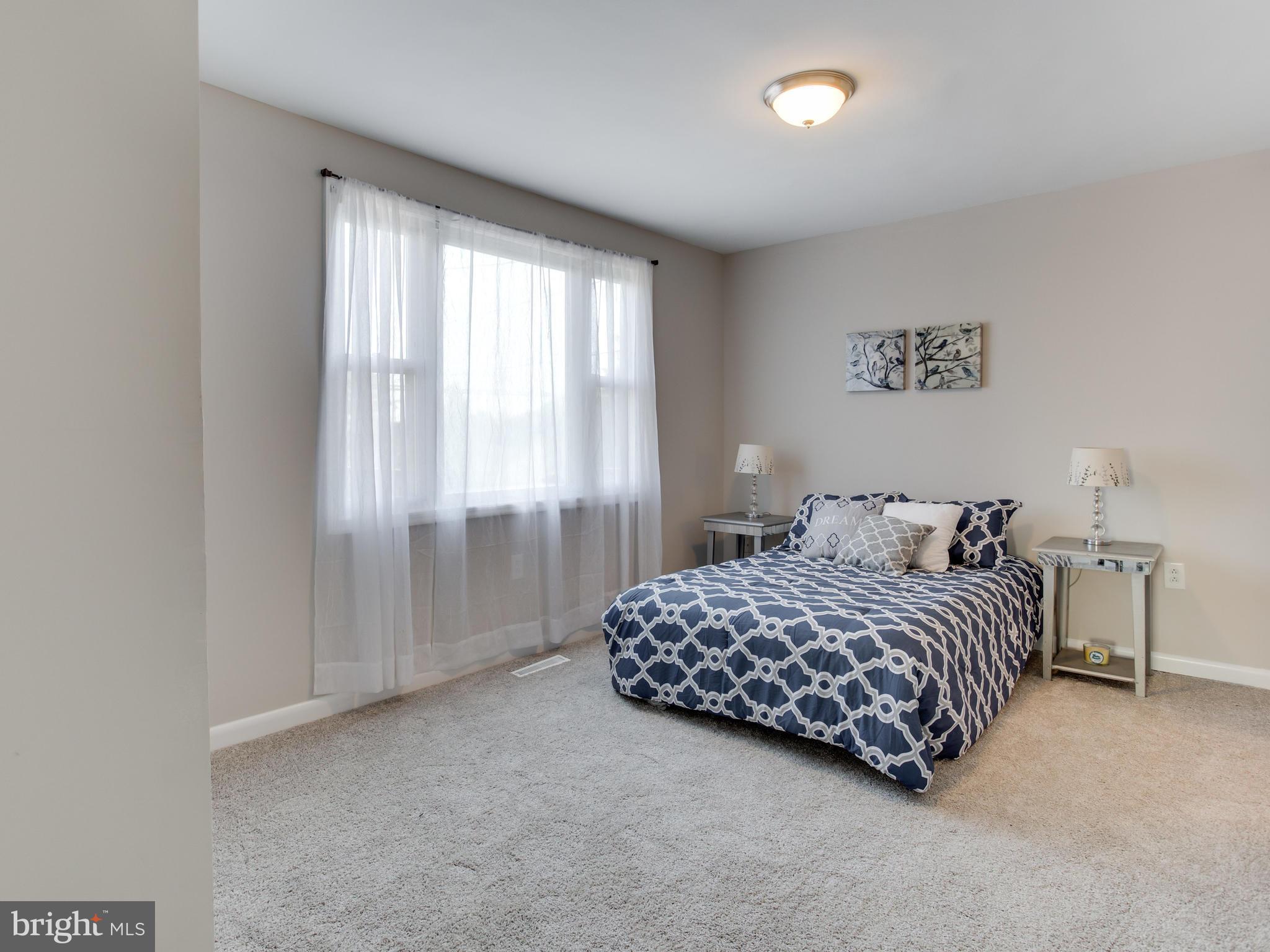 110 West Hilltop Road Baltimore, MD 21225 - Photo 17 of 30 a bedroom with a bed and a window