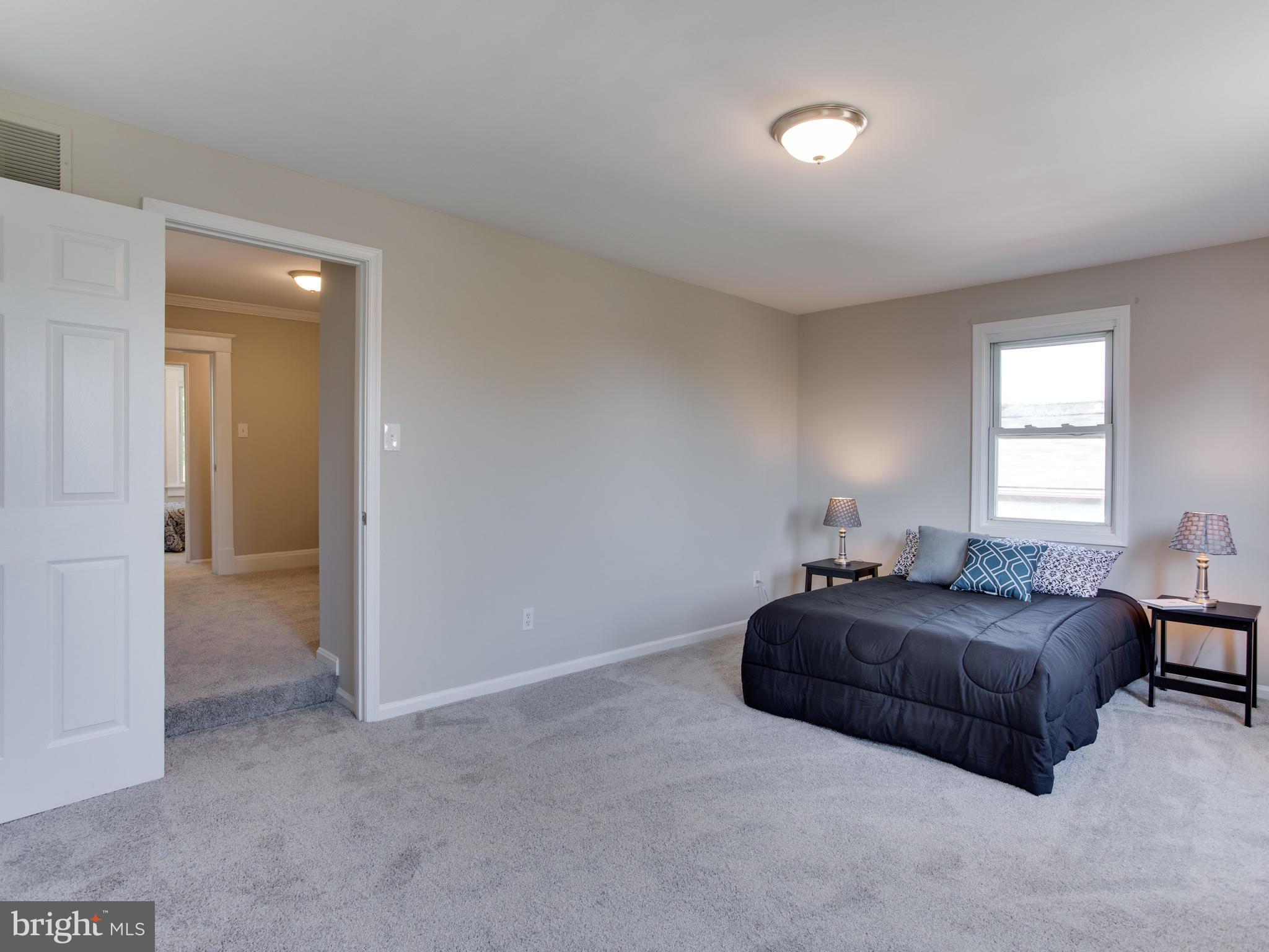 110 West Hilltop Road Baltimore, MD 21225 - Photo 21 of 30 a spacious bedroom with a bed and a chandelier