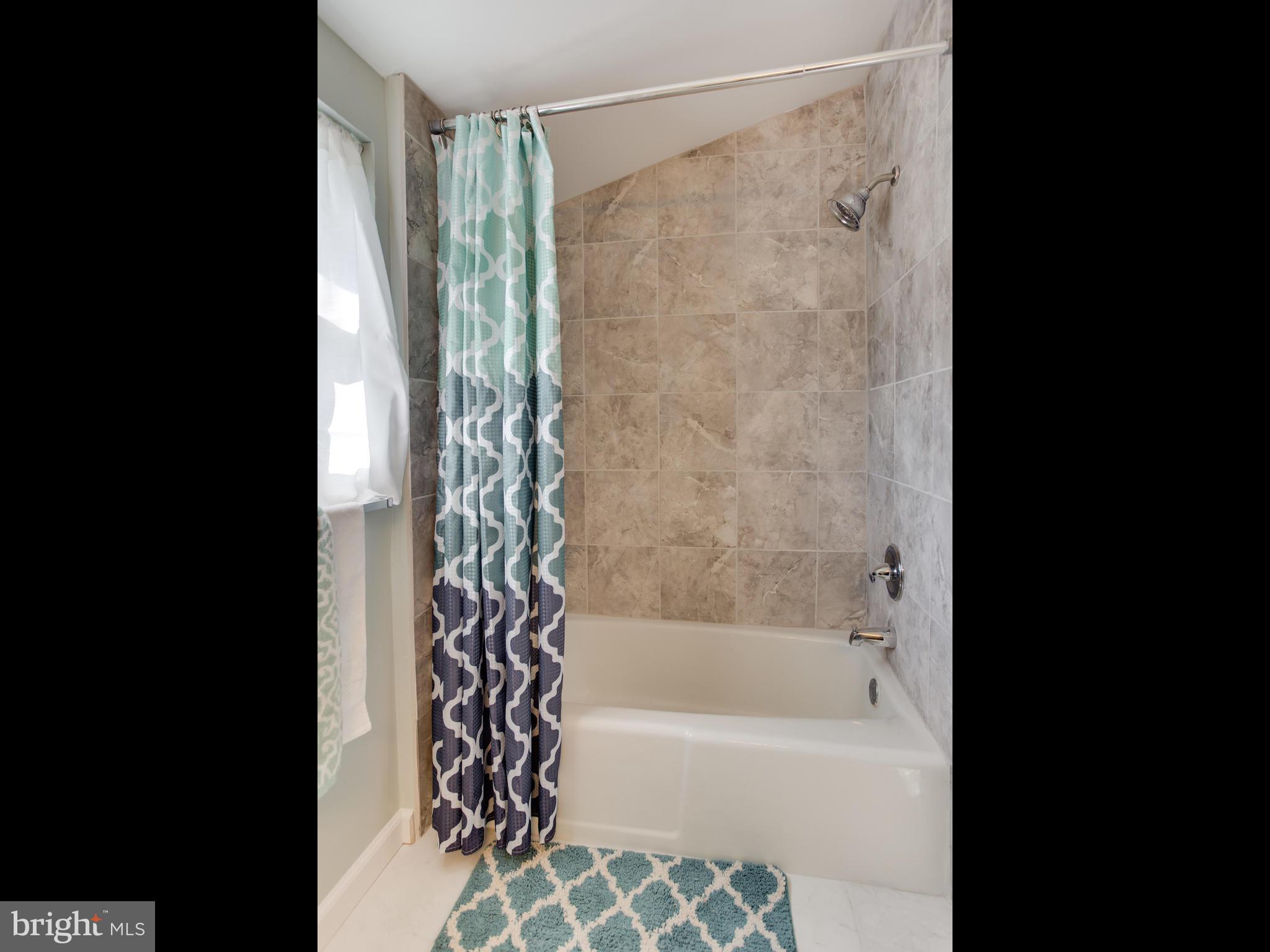 110 West Hilltop Road Baltimore, MD 21225 - Photo 25 of 30 a bathroom with a bathtub and shower