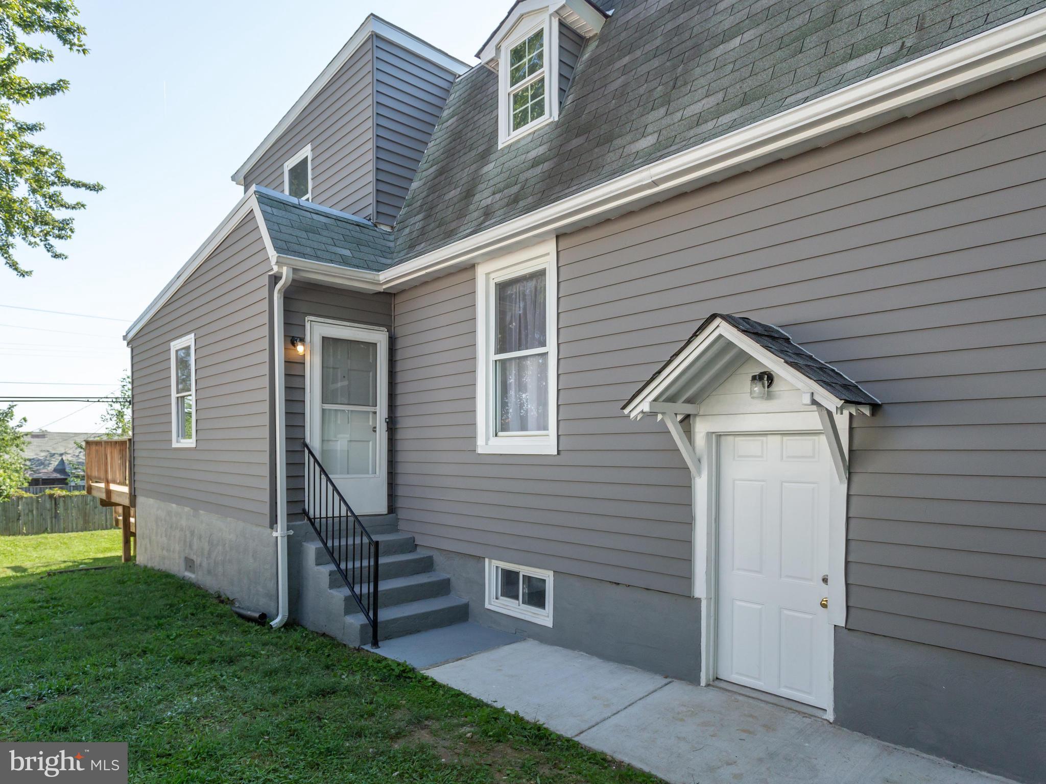 110 West Hilltop Road Baltimore, MD 21225 - Photo 26 of 30 a front view of a house with garden