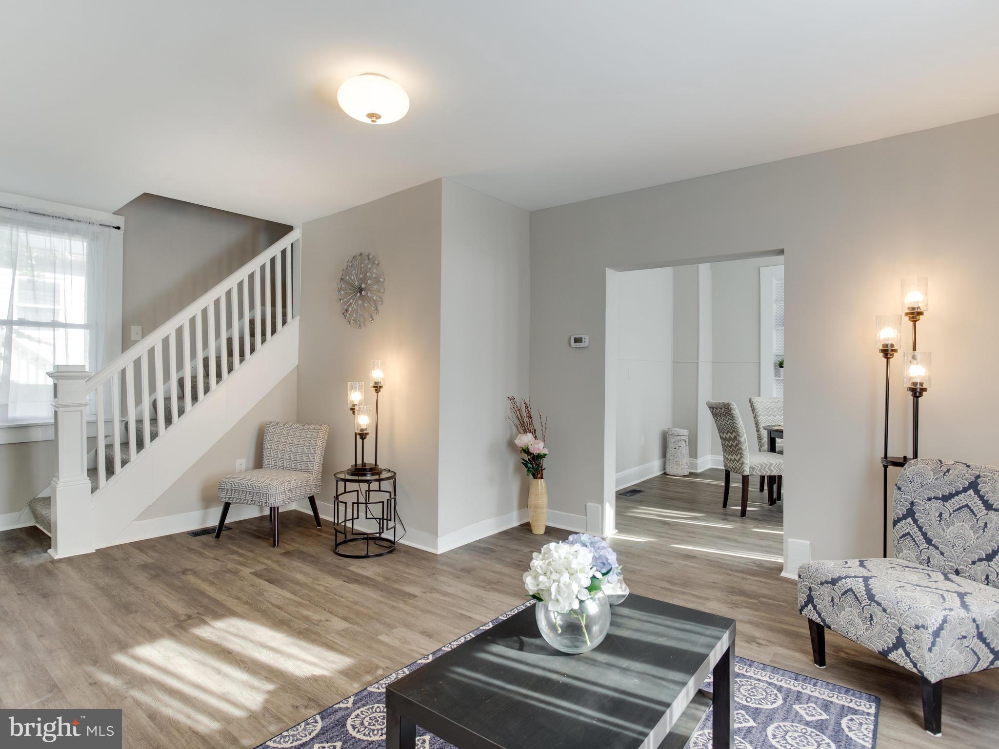 110 West Hilltop Road Baltimore, MD 21225 - Photo 6 of 30 a living room with furniture and wooden floor