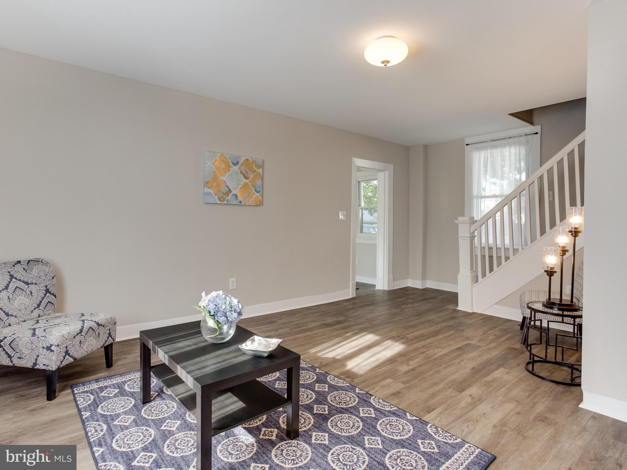 110 West Hilltop Road Baltimore, MD 21225 - Photo 7 of 30 a living room with furniture and wooden floor
