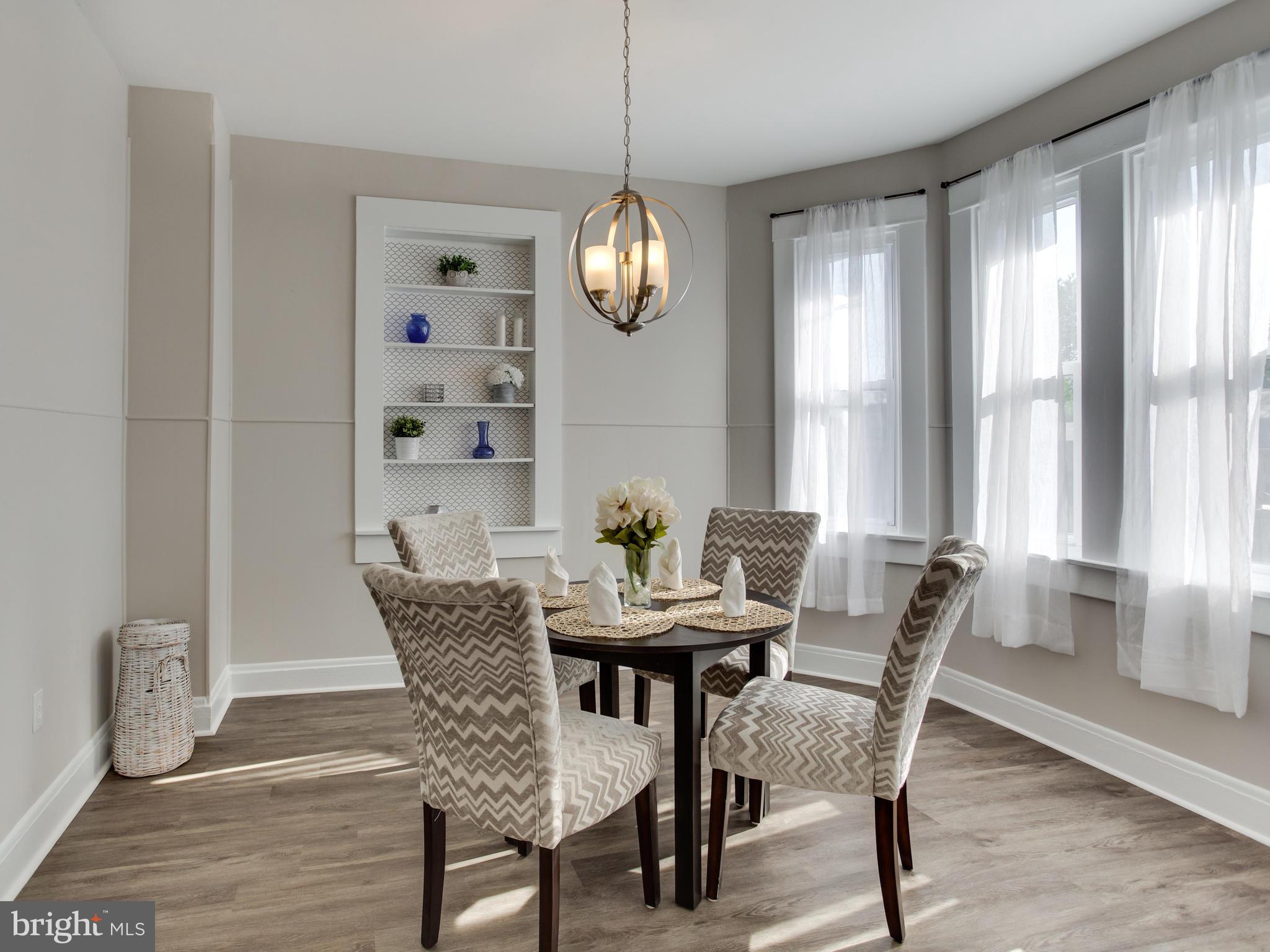 110 West Hilltop Road Baltimore, MD 21225 - Photo 8 of 30 a view of a dining room with furniture window and wooden floor