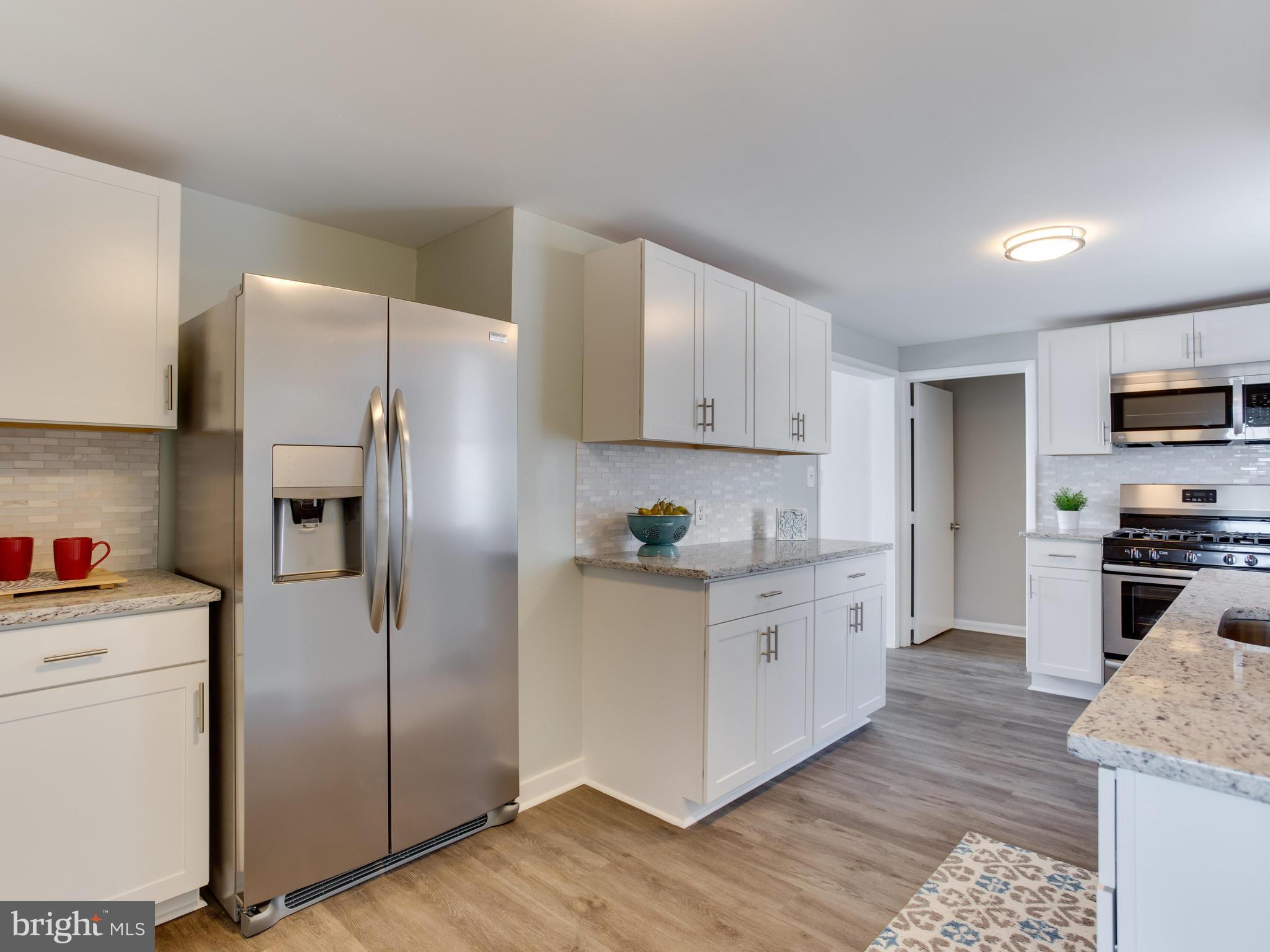 110 West Hilltop Road Baltimore, MD 21225 - Photo 10 of 30 a kitchen with stainless steel appliances a refrigerator sink and cabinets