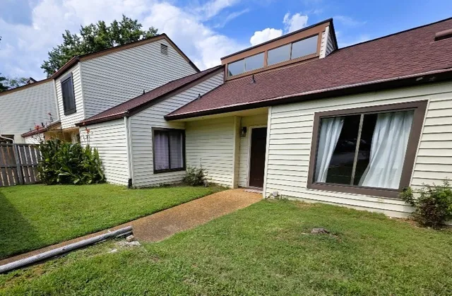 a front view of a house with a garden