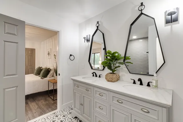 a bathroom with double vanity sink and a mirror