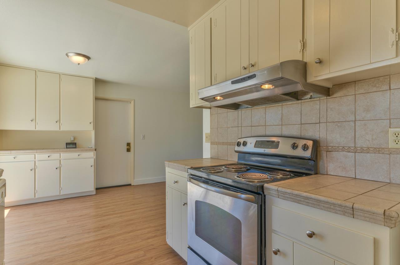 736 Sausal Drive Salinas, CA 93906 - Photo 11 of 24 a kitchen with appliances cabinets and a wooden floor