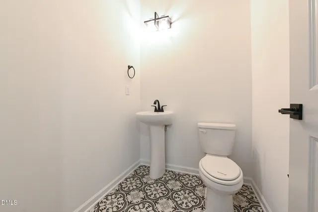 a bedroom with a large bed couch and windows