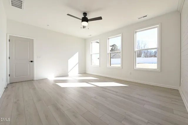 a spacious bathroom with a tub sink and mirror