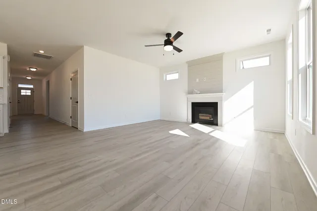 a view of a kitchen with wooden floor a sink and dishwasher