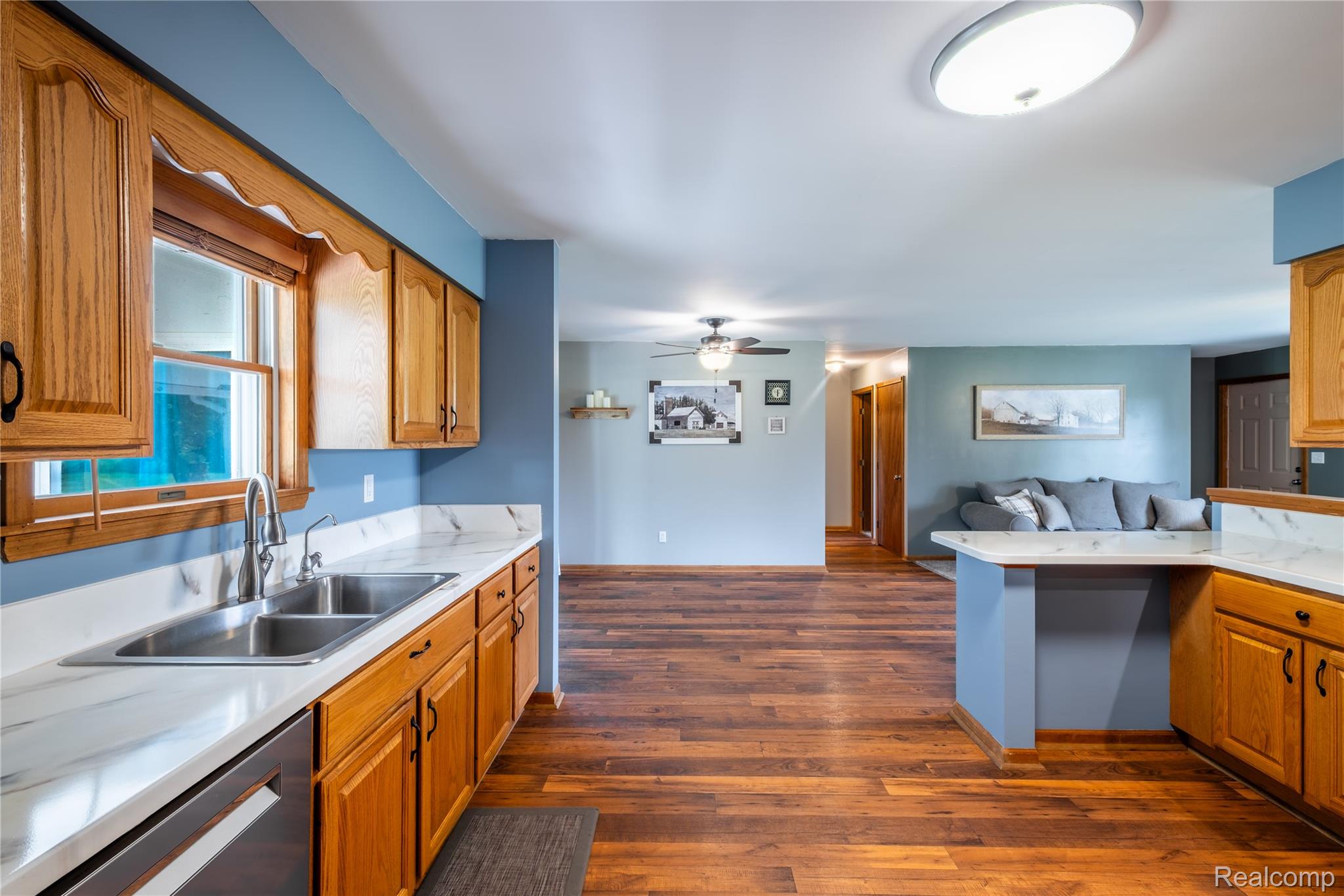 9600 Hamill Road Otisville, MI 48463 - Photo 10 of 32 Kitchen featuring wood cabinetry, a stainless steel double basin sink with a gooseneck faucet, and white countertops