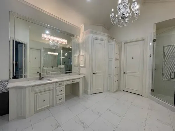 an empty room with wooden floor chandelier fan and windows