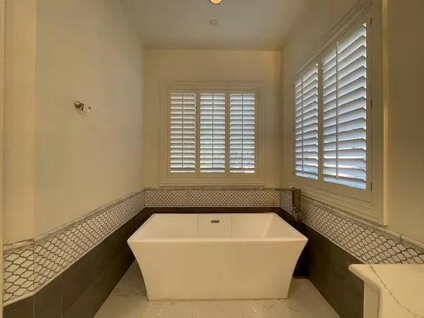 a bathroom with a granite countertop sink a large mirror and a shower