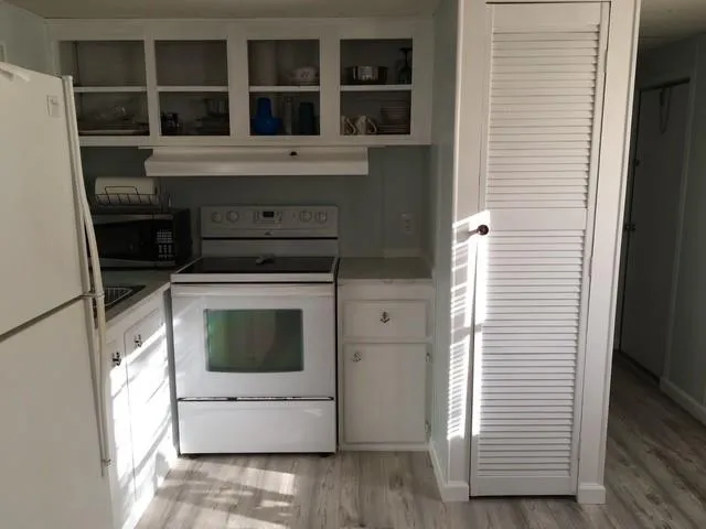 a large bed sitting in a bedroom next to a window