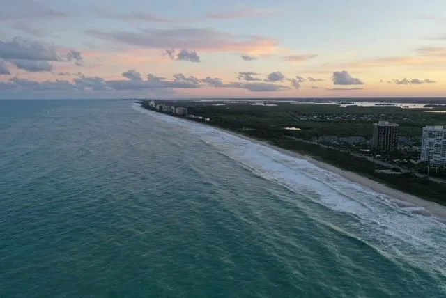 an aerial view of a house with a ocean view