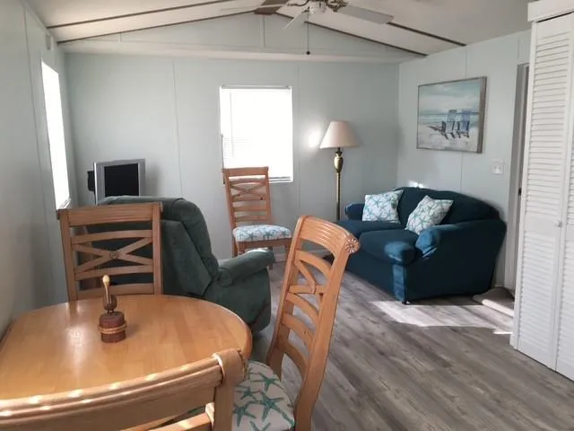 a view of a room with furniture and wooden floor