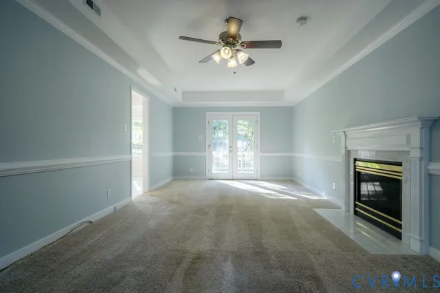 a view of an empty room with a fireplace and a window