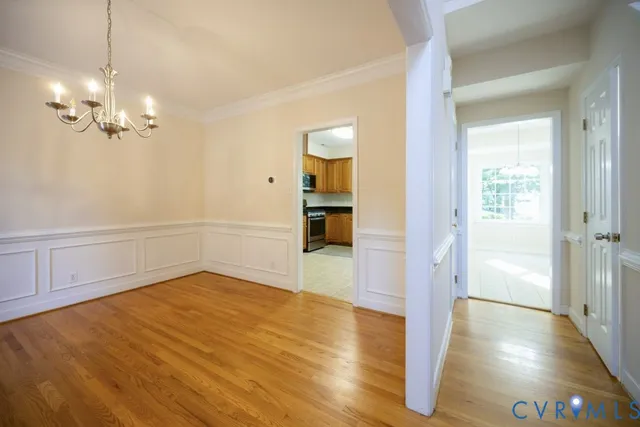a view of a room with wooden floor staircase and a kitchen