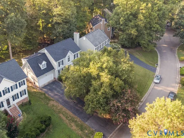 an aerial view of a house with a yard basket ball court and outdoor seating