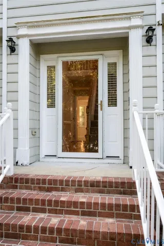 a view of wooden door and a window