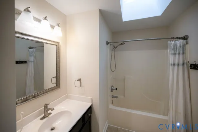a bathroom with a granite countertop shower a toilet and a bathtub