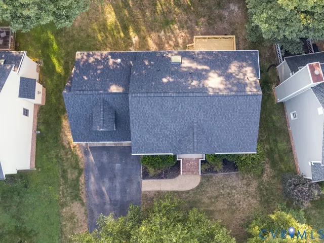 a aerial view of a house with a yard and potted plants