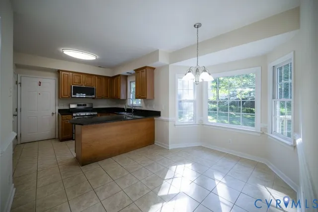 a kitchen with granite countertop a stove and a refrigerator