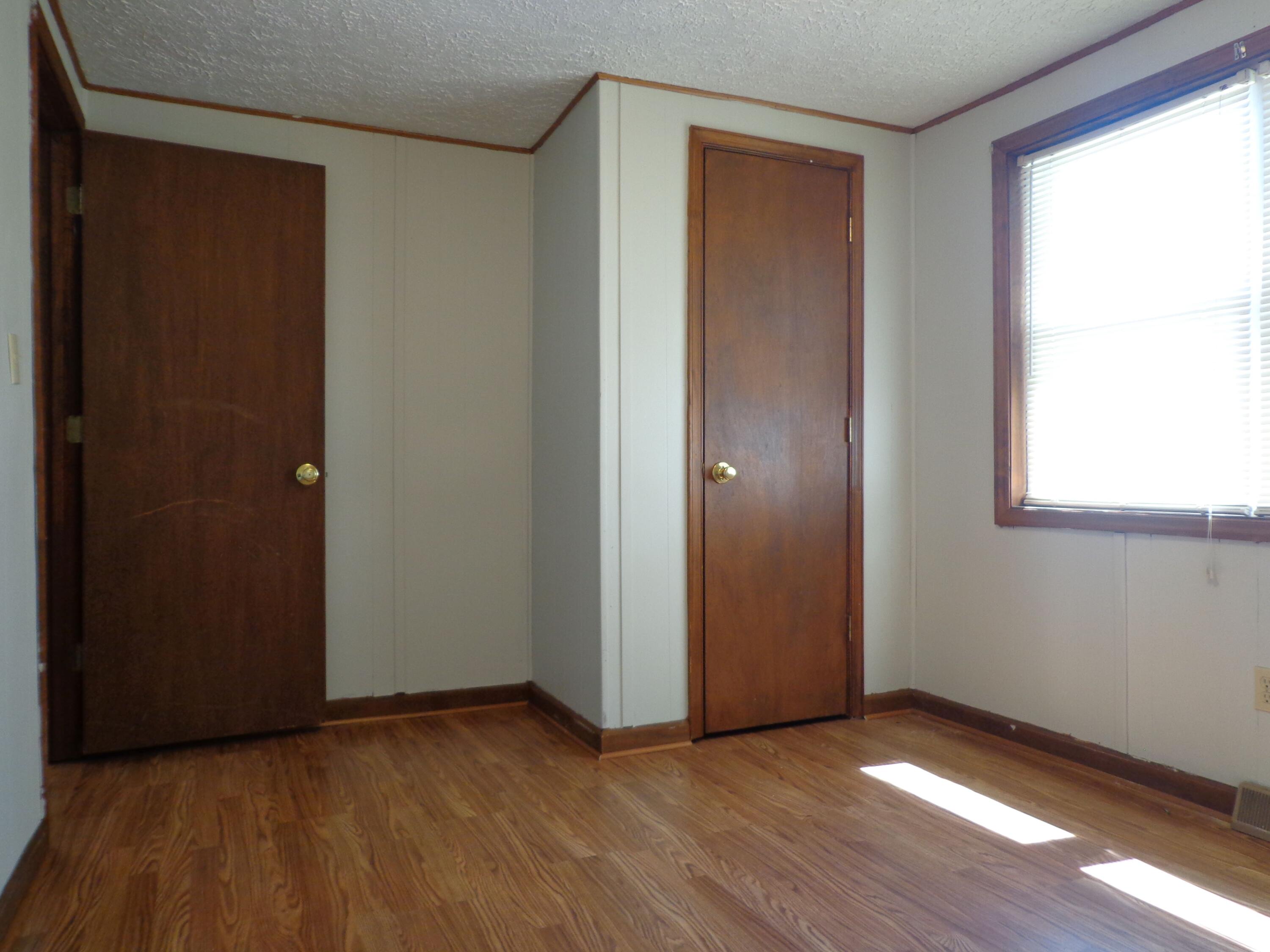 550 Hopkins Road Rocky Mount, VA 24151 - Photo 12 of 17 an empty room with wooden floor and windows