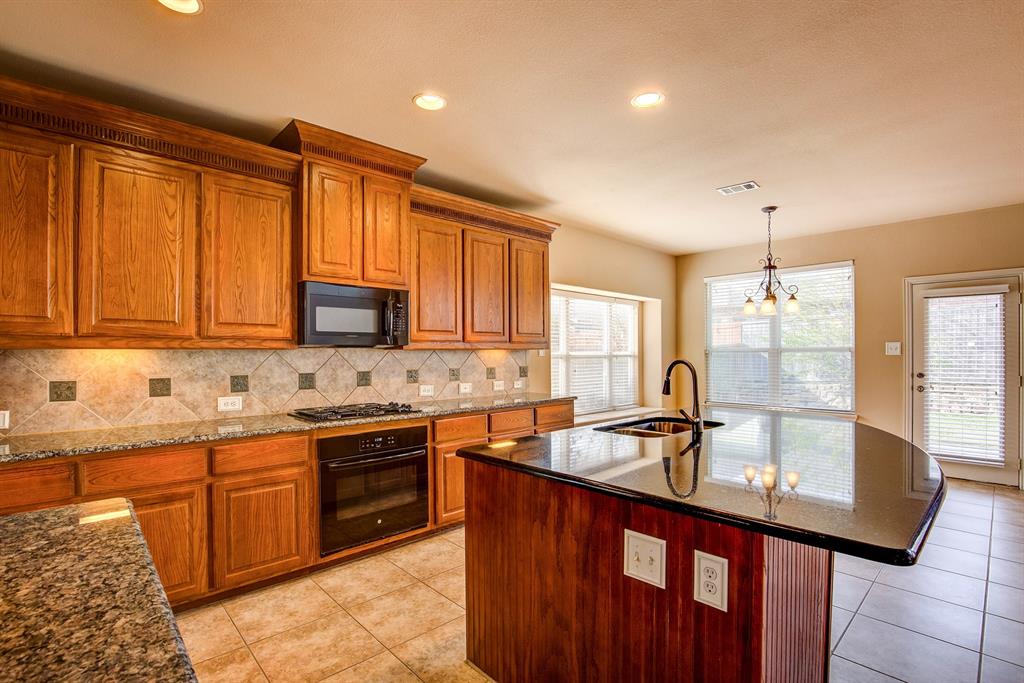 9017 Hawley Drive Fort Worth, TX 76244 - Photo 16 of 40 a kitchen with stainless steel appliances granite countertop a sink stove and cabinets