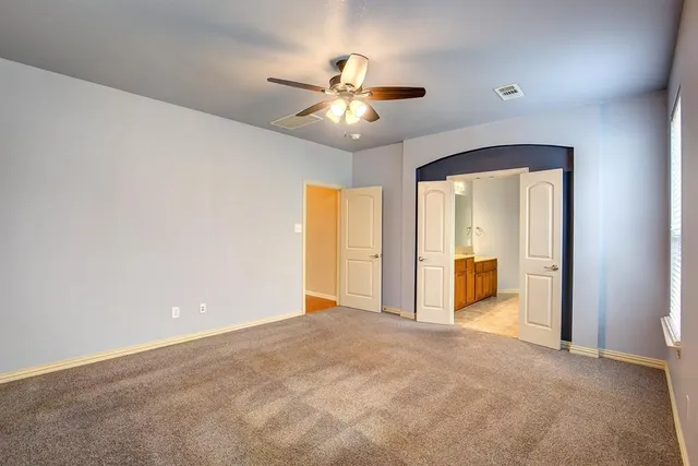 a view of a livingroom with a ceiling fan and window