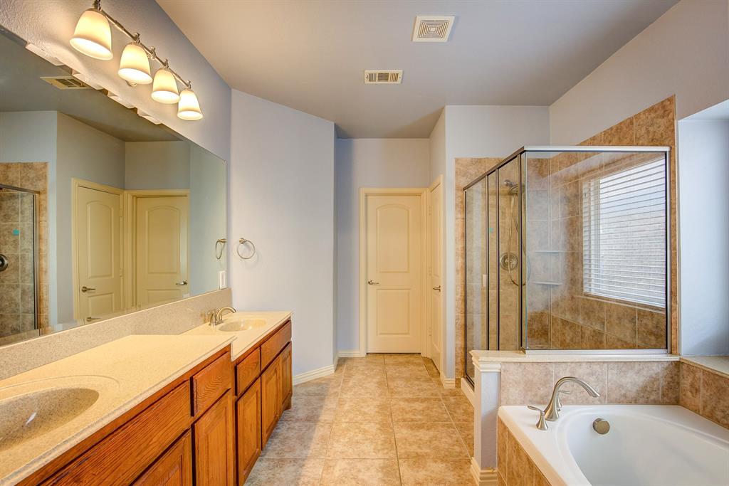 9017 Hawley Drive Fort Worth, TX 76244 - Photo 22 of 40 a spacious bathroom with a tub sink and mirror