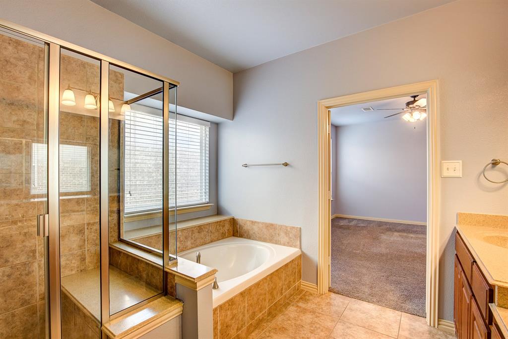 9017 Hawley Drive Fort Worth, TX 76244 - Photo 23 of 40 a bathroom with a tub and a shower