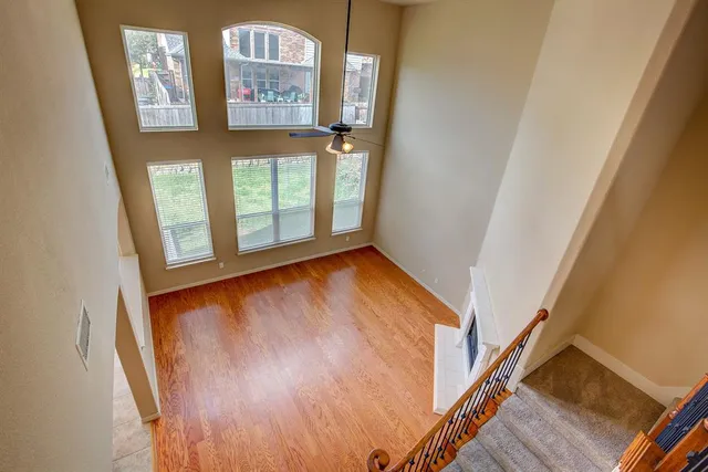 an empty room with windows and cabinet
