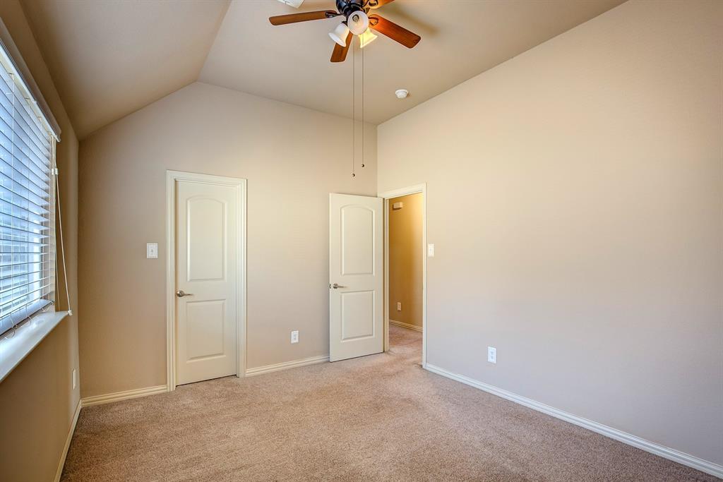 9017 Hawley Drive Fort Worth, TX 76244 - Photo 30 of 40 an empty room with a ceiling fan and carpet