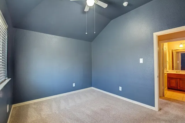 a bathroom with a sink a toilet and a large mirror