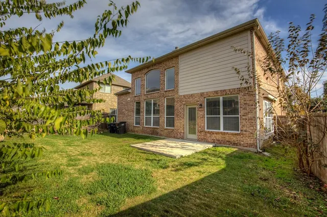 a view of a backyard with a fence