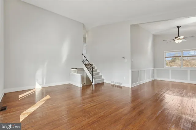 wooden floor in an empty room with a window