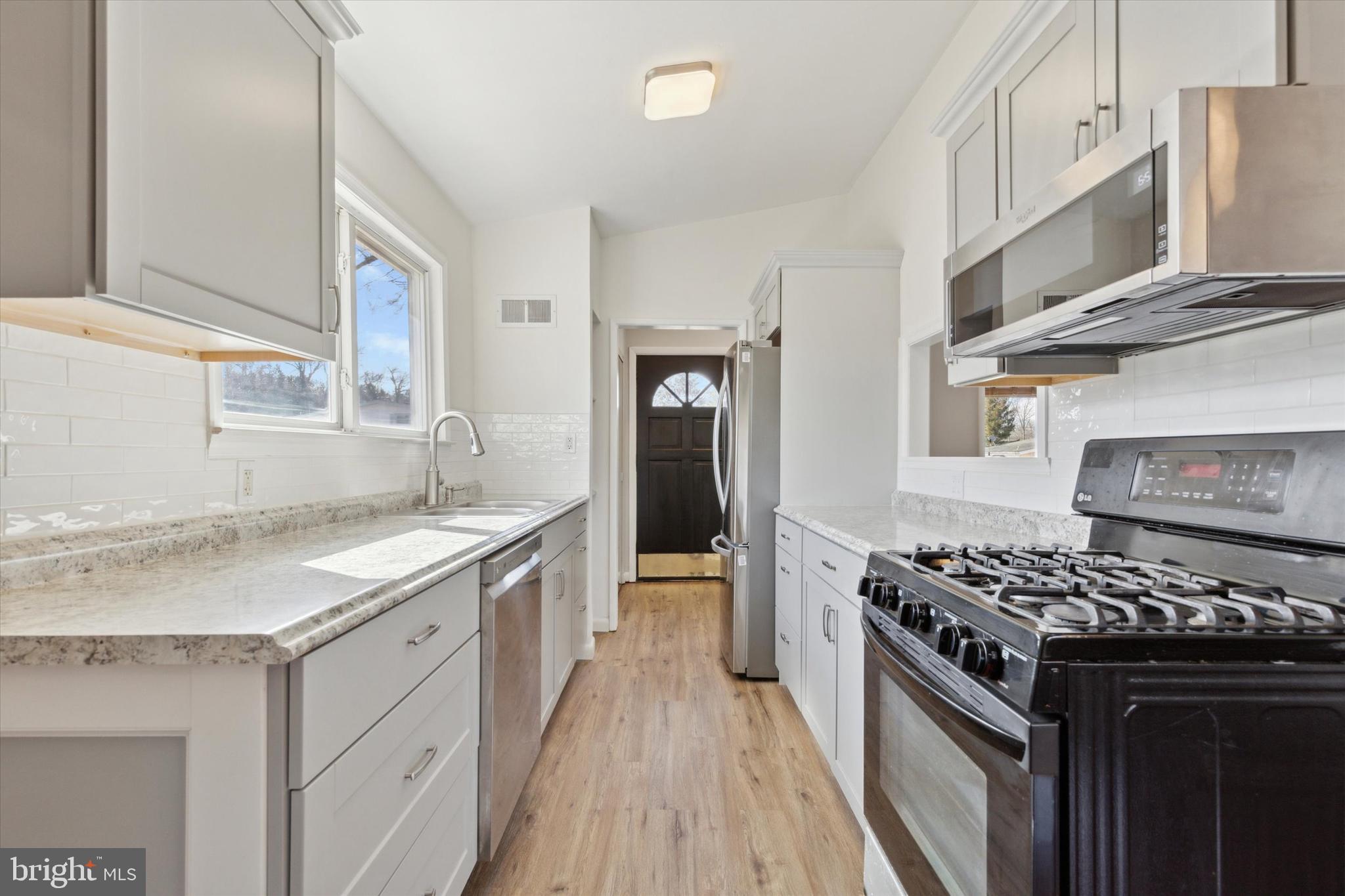 1633 Pulaski Drive Blue Bell, PA 19422 - Photo 6 of 13 a kitchen with stainless steel appliances granite countertop a stove and a sink