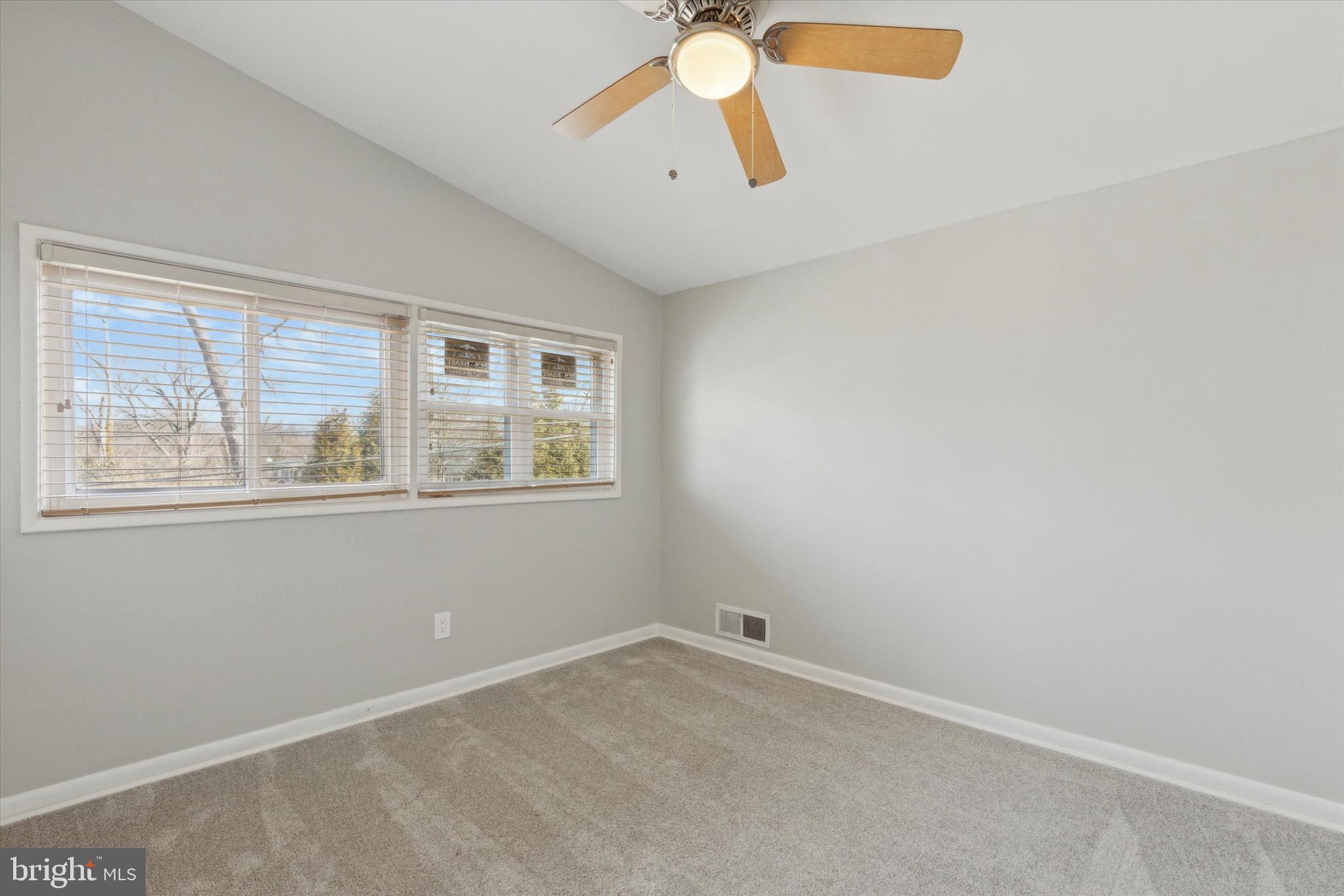 1633 Pulaski Drive Blue Bell, PA 19422 - Photo 8 of 13 an empty room with a window and a fan