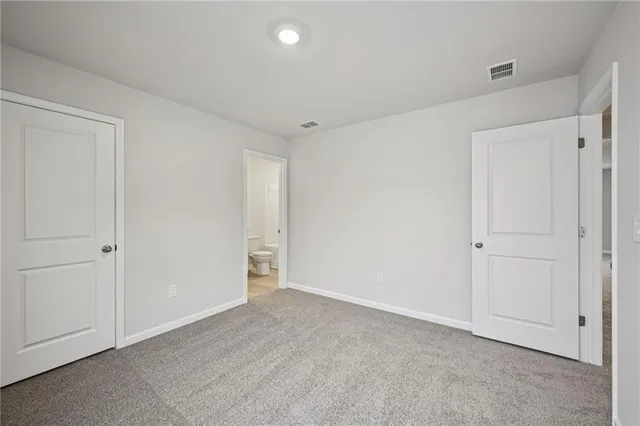 a bathroom with a granite countertop sink toilet a mirror and bathtub