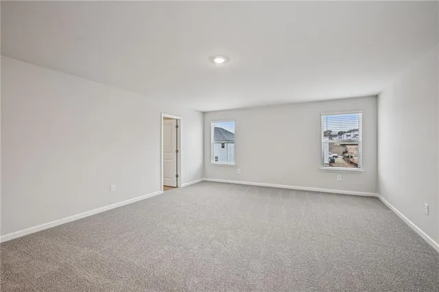 a spacious bedroom with a bed and a couch