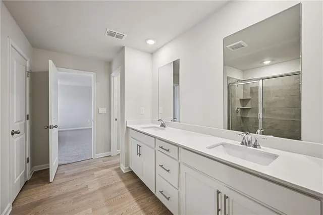 a bathroom with a shower and a glass door