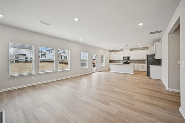 a view of kitchen with stainless steel appliances refrigerator oven and cabinets