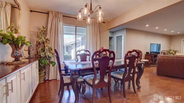 a view of a dining room with furniture and chandelier