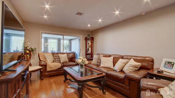a living room with furniture a rug and a chandelier