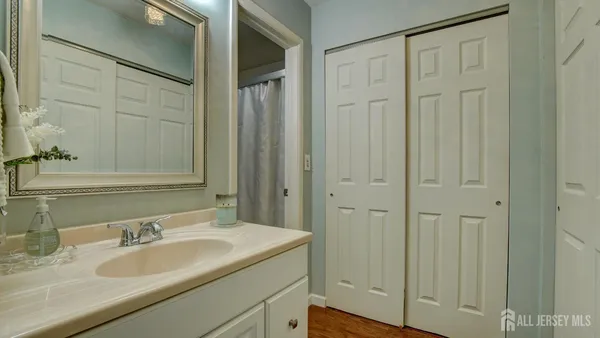 a bathroom with a granite countertop sink and a mirror