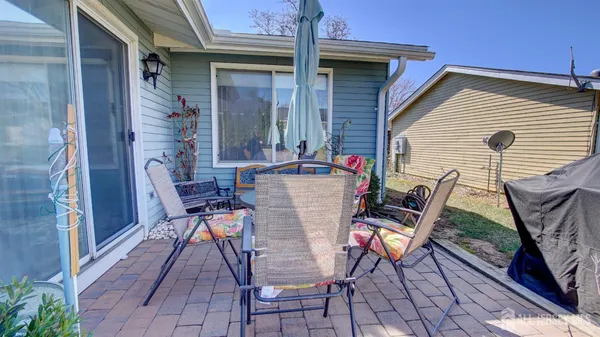 a view of a patio with table and chairs and potted plants